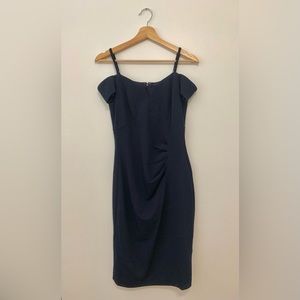 Curve hugging navy off shoulder cocktail dress
